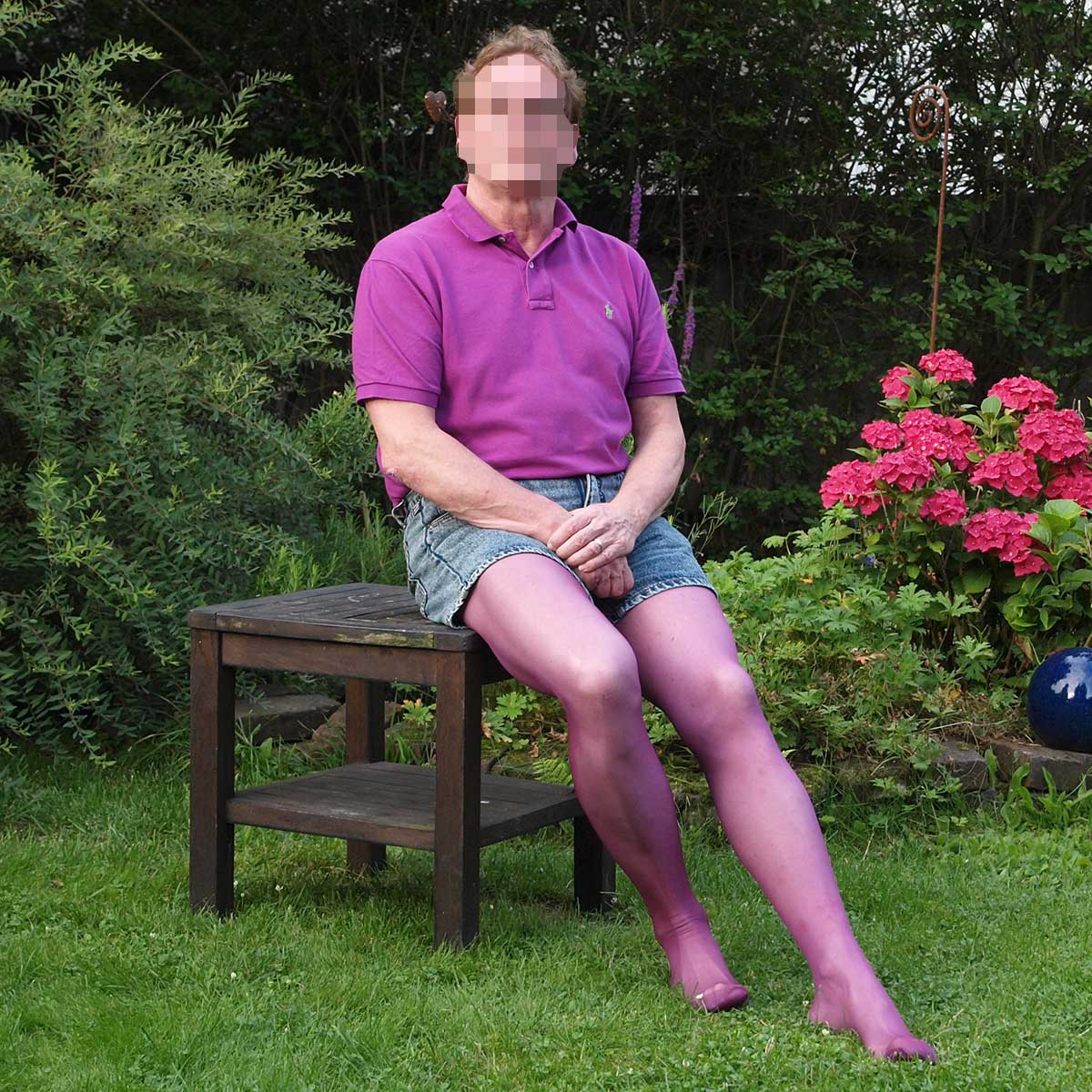 Ein Mann trägt eine lilafarbene Feinstrumpfhose.